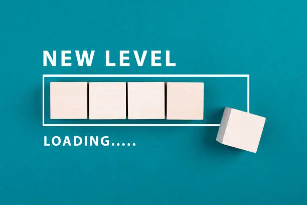 Photo of Loading bar with the words new level, education and business concept, progress in a game, step up for a different challenge