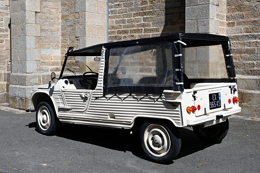 Pléneuf-Val-André, France - June 28, 2022: An old being old timer classic Citroën Méhari car in a very good shape. A lightweight recreational and utility vehicle, manufactured and marketed by French carmaker Citroën over 18 years(1968–1988) in a single generation.