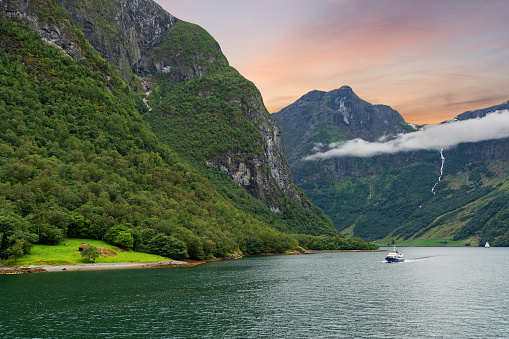 Sognefjord - Norwegian fjords sea mountain sunset landscape with sailing vessel, sea way to Neroyfjord. Norway