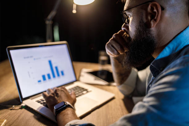 istock Businessman reviewing a graph on laptop and pondering 1405871678