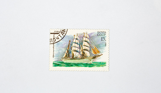 Old collectible stamp of the USSR Post with the three-masted barque Comrade closeup against white. Circa 1981.