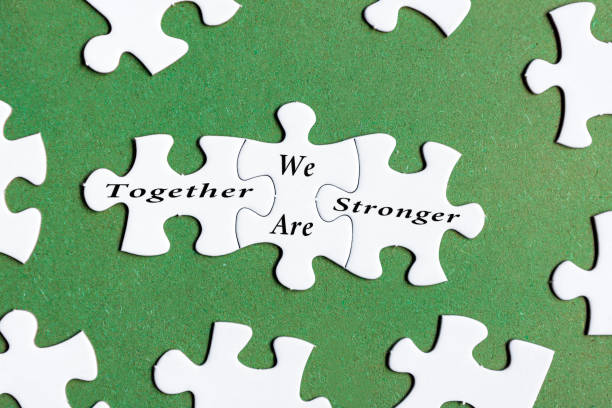 istock Motivational and inspirational text on white jigsaw puzzle with green background 1405874023