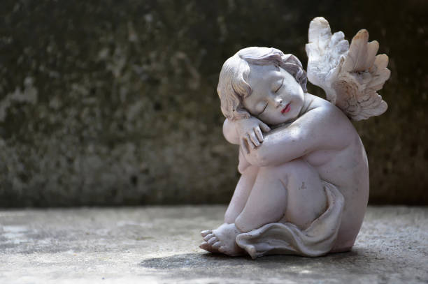 istock Guardian angel sleeping on concrete background with copy space 1405874329