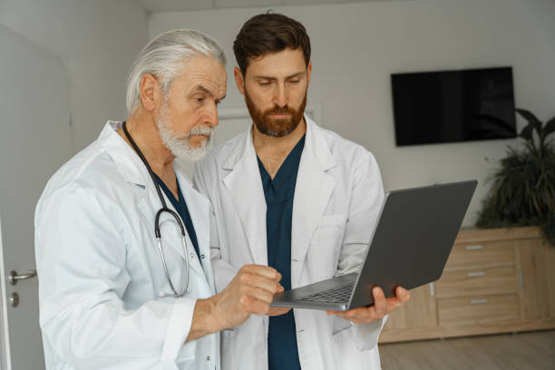 istock Two doctors are looking at something on the laptop in the doctor's office 1405875156