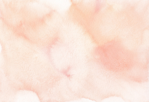 Watercolor pastel peach color background texture. Light cream color stains on paper, hand painted.