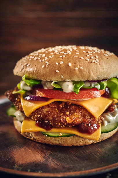 istock Crispy Chicken Burger with Cheese, Tomato, Onions and Green Salad 1405876804