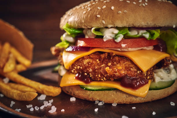 istock Crispy Chicken Burger with Cheese, Tomato, Onions and Green Salad 1405876815