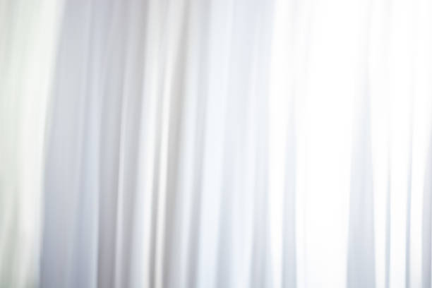 istock Background of white curtains, waves and folds. 1405878112