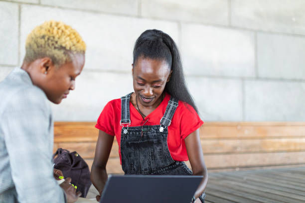 istock Two black female students studying with laptop outdoors 1405879413