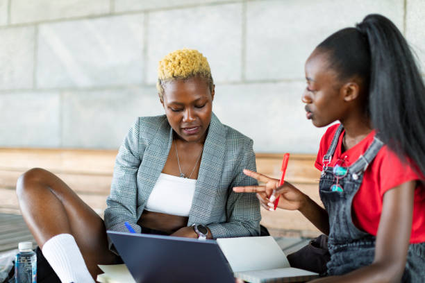 istock Two black female students studying with laptop outdoors 1405879500