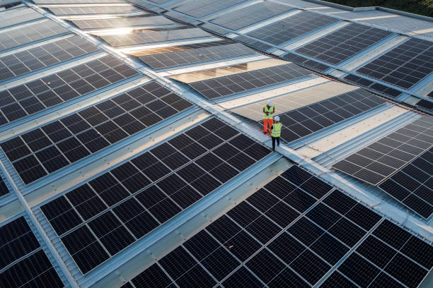 istock Two engineers on roof with solar panels system. 1405880242