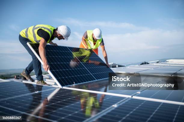 Two Engineers Installing Solar Panels On Roof Stock Photo - Download Image Now - Solar Panel, Solar Energy, Solar Power Station