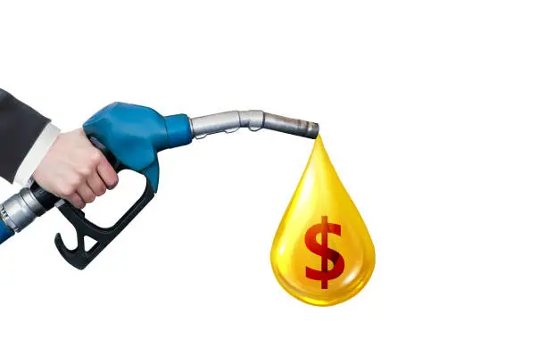 Oil dripping from a gasoline pump with dollar sign on white background