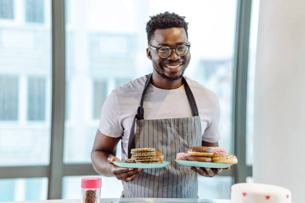 istock Young African American man serving cookies and doughnuts 1405881716