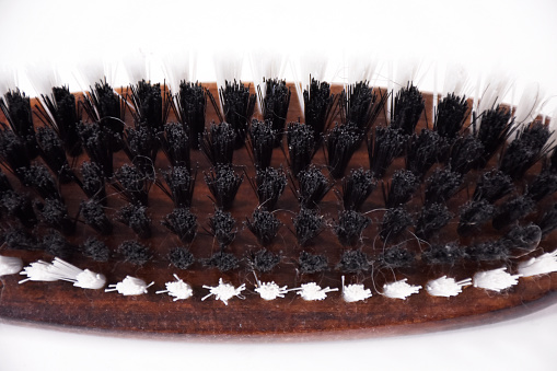 Close-up dirty shoe brush on the white background