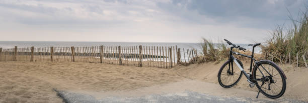 Panorama of beach with bicycle in Belgium