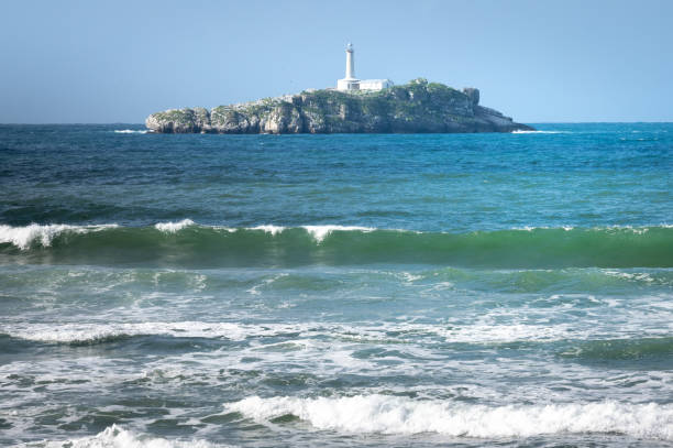 Mouro lighthouse from El Puntal beach, bay of Santander, Spain stock photo