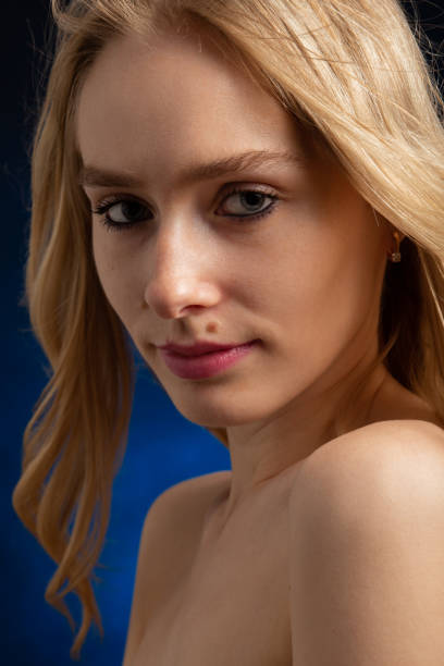 istock sad beautiful blonde transgender with bare shoulders looking at camera 1405889552