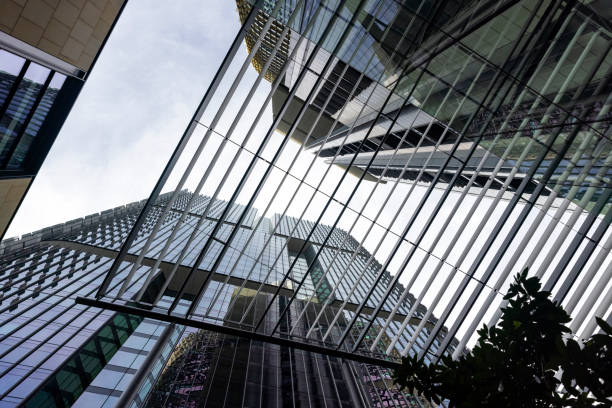 Low angle view of modern corporate buildings, view through sunshade, background with copy space, full frame horizontal composition