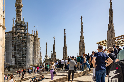 People on the roof of the Milan Cathedral are waiting in queue to go down.