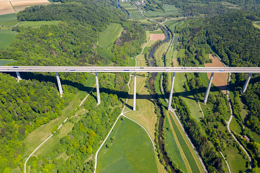 Aerial view of car traffic on highway bridge in summer scenery.