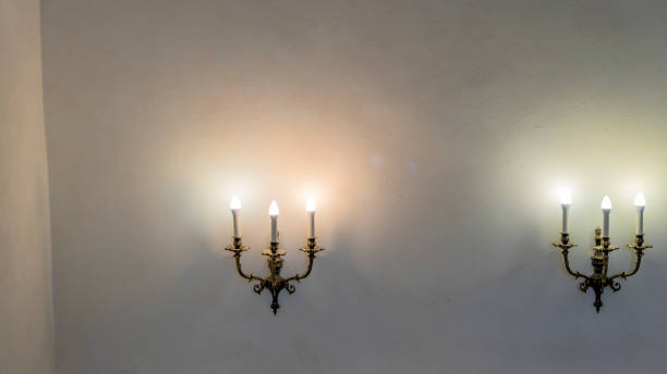 istock Vintage wall lamp. Space for text. Lamp light on the wall. Working lamps at dusk. 1405893805