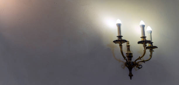 istock Vintage wall lamp. Space for text. Lamp light on the wall. Working lamps at dusk. 1405893824