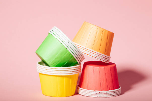 istock Multi-colored paper molds for muffins and cupcakes on a pink background 1405895032