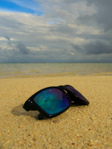 istock Sunglasses on the beach 1405895048