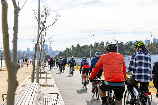 Sydney, Australia - June 26, 2022: Group of cyclists and people enjoying beautiful sunny afternoon in  Barangaroo Sydney Australia