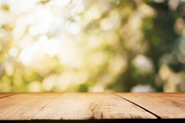 istock Empty blank wooden plank, deck or table with defocused green trees background 1405898198