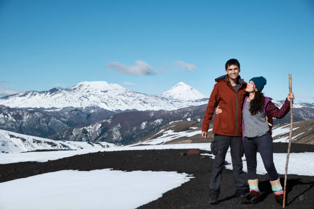 Couple enjoying the landscapes during a trekking. Villarrica , Chile Young adult couple enjoying the landscapes of Patagonia during a trekking. Villarrica National Park, Chile chile tourist stock pictures, royalty-free photos & images