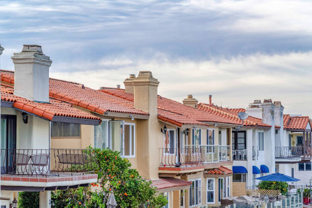 istock Waterfront homes with balconies and patios against blue sky and bright clouds 1405902918