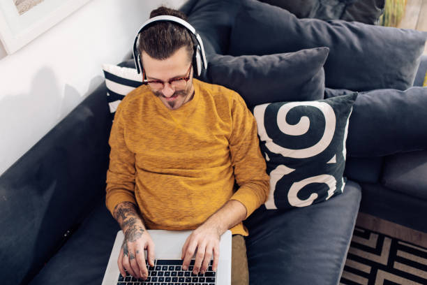 istock Happy freelancer enjoying on the sofa and working 1405906539