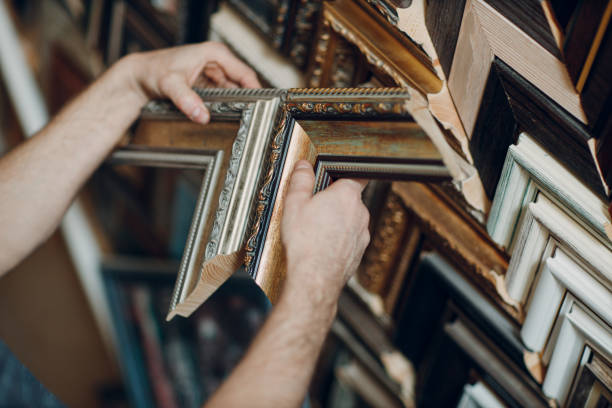Framing Workshop. Making baguette handmade picture frame at studio Framing Workshop. Choose and check baguette handmade picture frame at studio. hand cropping photos stock pictures, royalty-free photos & images