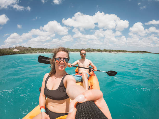 istock Couple exploring Bacalar lake with kayak 1405906786