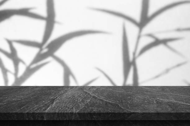 istock Marble table top with tree shadow drop on white wall background for mockup product display 1405906836
