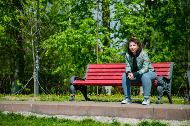 istock Young woman sitting on a bench 1405906885