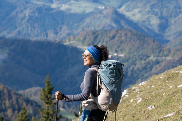 istock Smiling Hispanic woman with backpack admiring view on landscape 1405908120