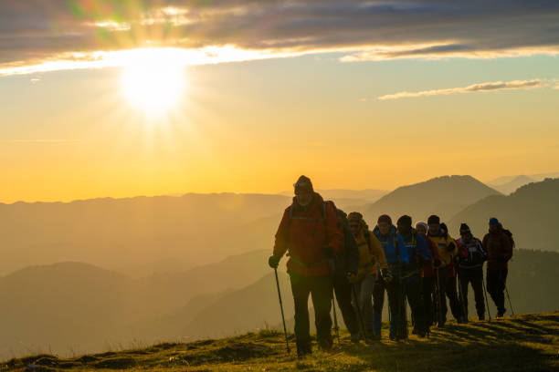 istock Group of people walking lined behind each other in nature 1405908121