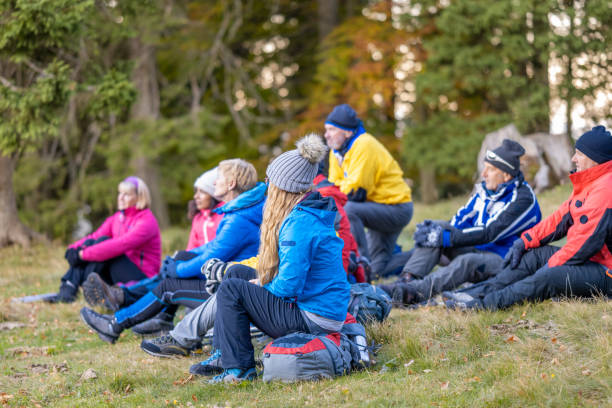 istock Men and women resting on grass or backpacks 1405908130