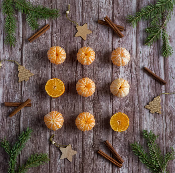 istock Orange mandarins with branches Christmas tree and cinnamon on wooden background 1405908165