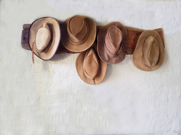 istock Five old leather hats handing on the wall 1405912165