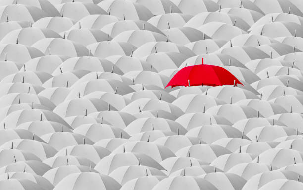 istock Red umbrella surrounded by many white umbrellas 1405914332