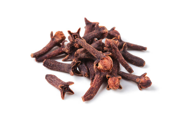 Handful of dried cloves Handful of dried cloves isolated on white background clove spice stock pictures, royalty-free photos & images