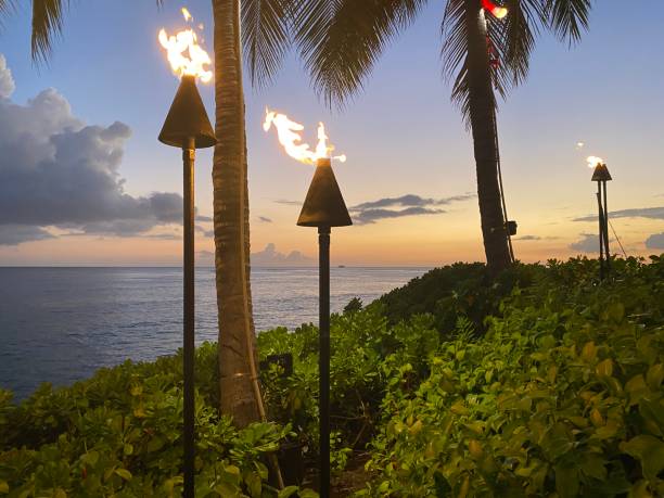istock Fire lamps along the Ocean as the Sun Sets 1405920108