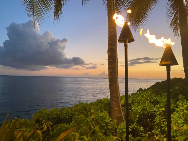 istock Fire lamps along the Ocean as the Sun Sets 1405920125