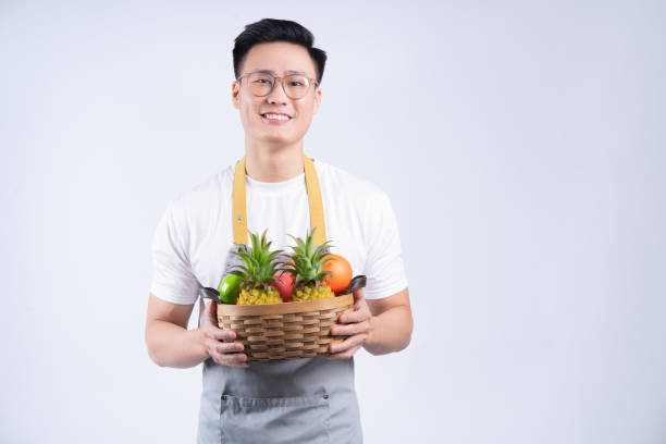 istock Image of young Asian waiter on background 1405923713