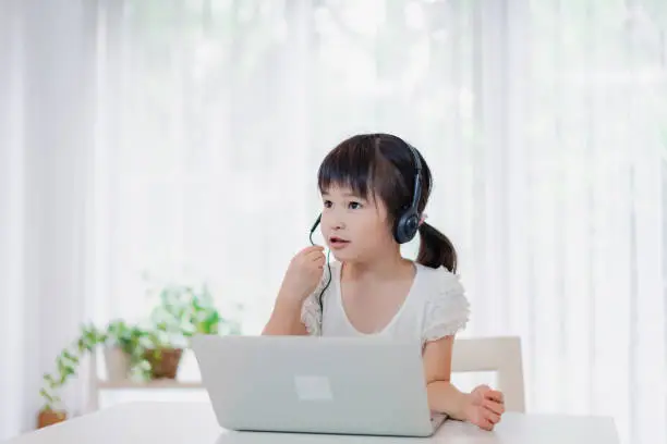 Photo of Little girl using the computer
