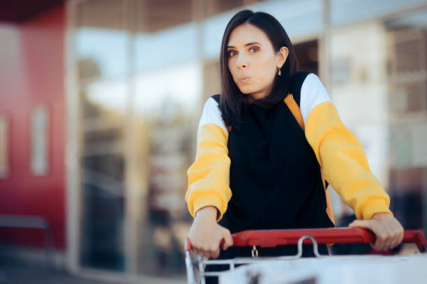 istock Happy Cheerful Supermarket Customer Pushing a Trolley 1405929245